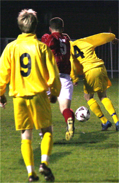 Clinton More (9) watches as Stuart Hack (5)  and Tim Fewster (4) compete for the ball
