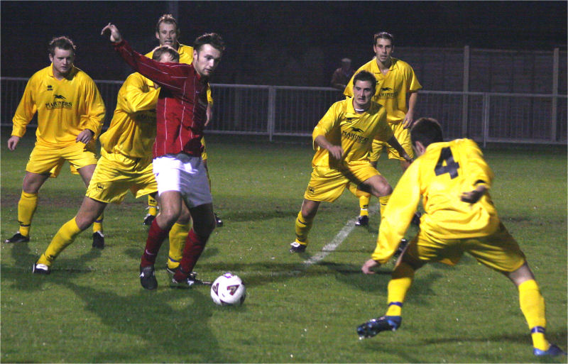 Dave Walker is surrounded by six Selsey players ...
