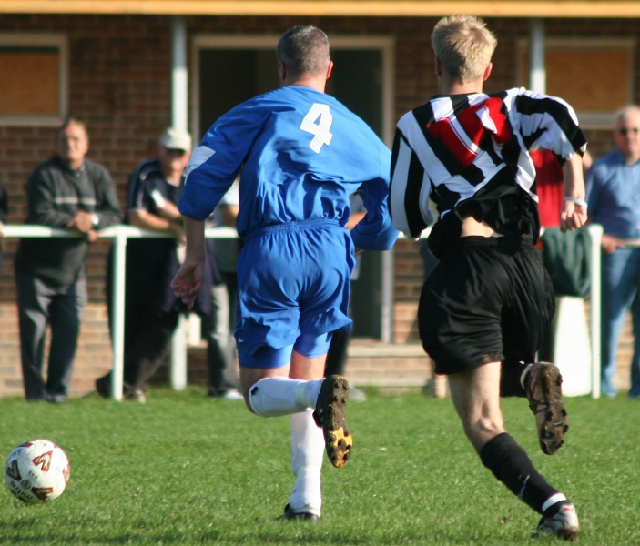 Storrington's Andy Long (4) and Sam Jeremiah (10) chase the ball
