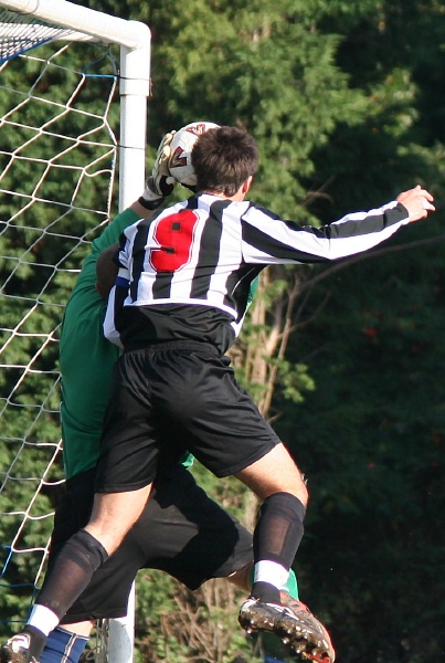 Storrington keeper Paul Smith grabs this cross under pressure from Phil Gault (9)
