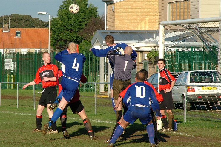 Russ Tomlinson (4), Andy Smart (9) and keeper Gary Newman all go for this cross watched by Steve Wood (10)
