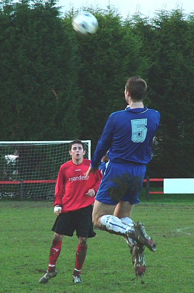 Danny Gainsford (5) heads forward watched by Marc Cooper
