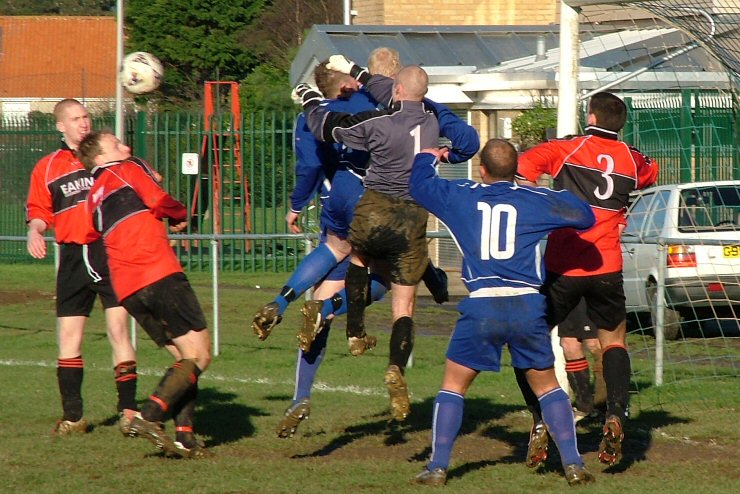 Gary Newman punches the ball away despite pressure from Russ Tomlinson and Andy Smart
