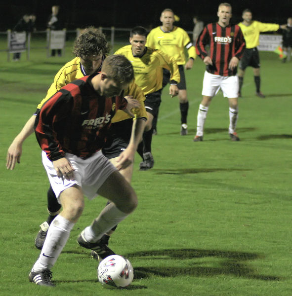 Danny Curd on the ball with Roy Pook, Paul Williams and Gary Young queueing up 
