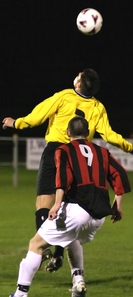 Paul Williams beats Tom Bird (9) to a header
