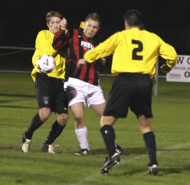 Danny Curd is closed down by Owen Hill and Paul Williams (2)
