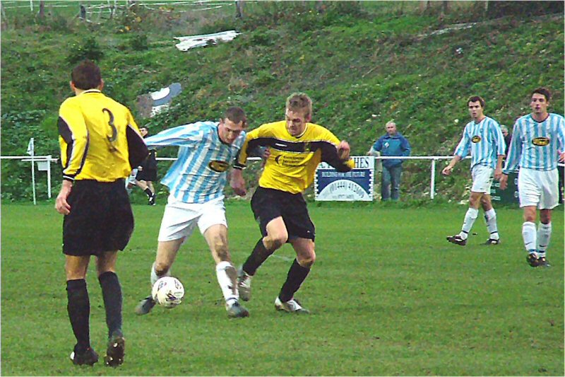 Worthing United's Neil Shelley holds off a challenge
