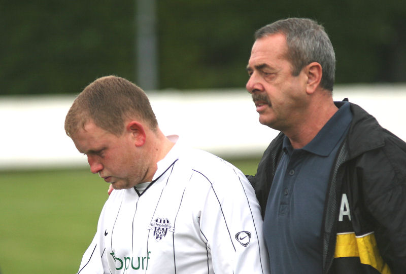 Physio Dick Appleton brings the unfortunate Paul Brown off with a broken nose
