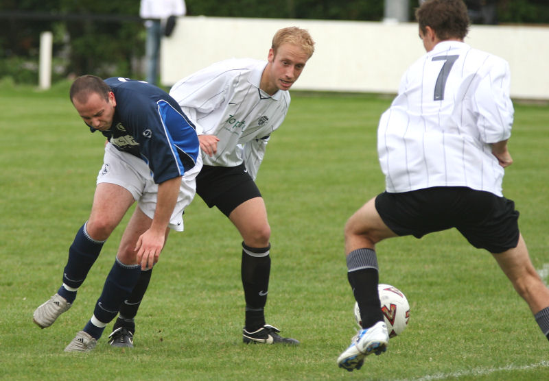 Dave Hall and Ryan Dick keep the ball away from Dave Adams
