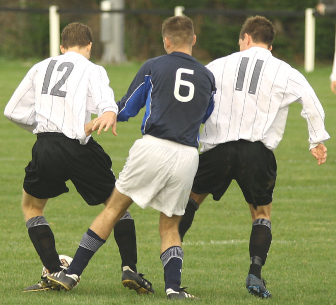 Chris Yelling (12) and Matt Axell (11) keep the ball from Danny Baker (6)
