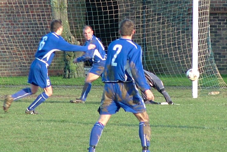 Gary Newman saves with Benn Challen (6), Steve Wood and Sean Duffy (2) ready to pounce
