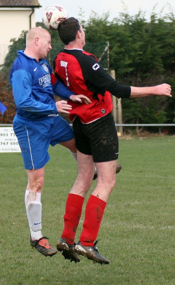 Russ Tomlinson and Anthony Potter go for a header
