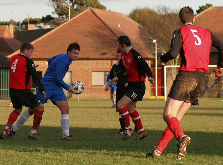 Ryan Walton goes between Nick Pollard and Dan Waite
