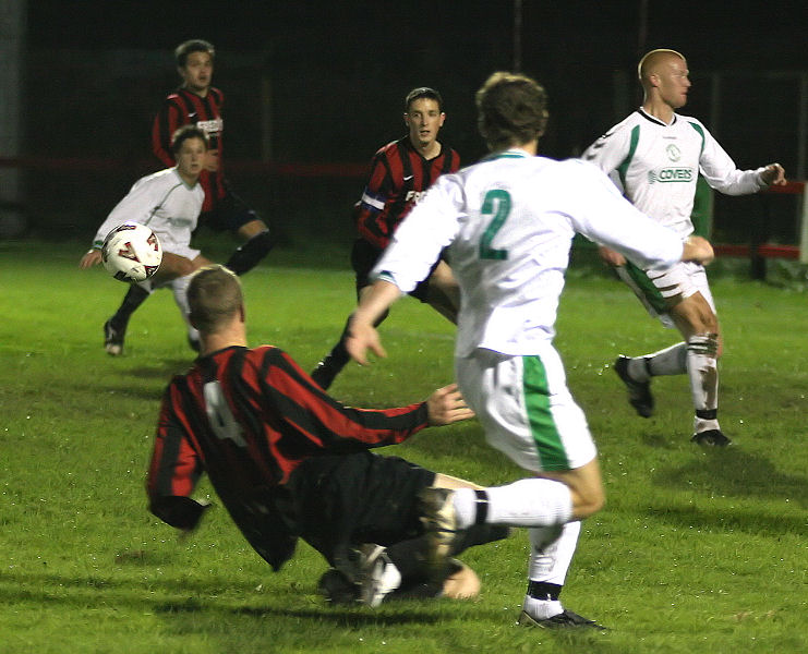 Paul Hodder (4) cuts out this ball to Neil Murfin (2)

