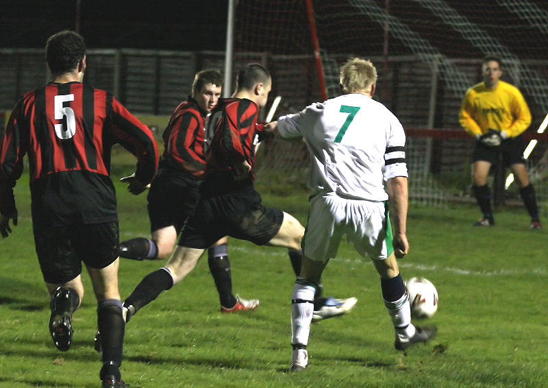 This attempts by Alex Ward is cut out by Tom Bird with Pete Christodoulou (5) and Lee Howard backing up 
