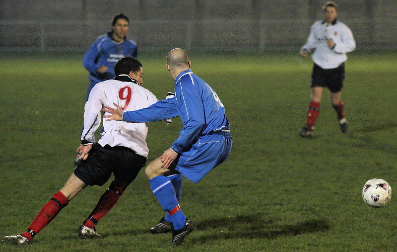 Matt Robb and Stuart Townsend turn for the ball
