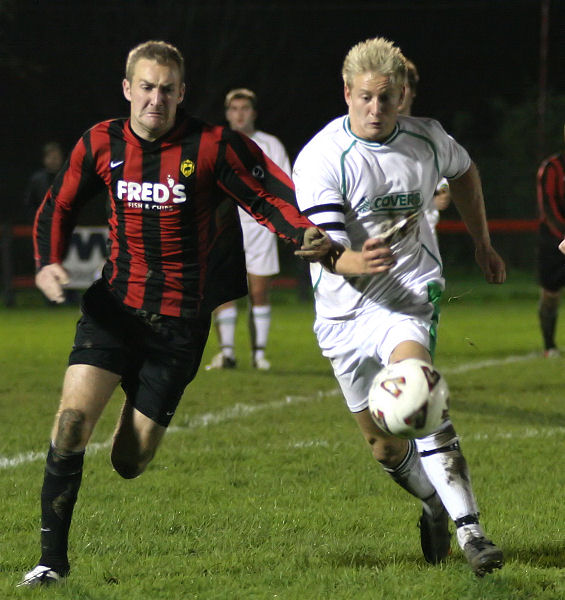 Paul Hodder and Alex Ward scrap for the ball
