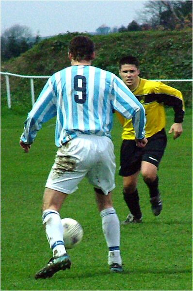 Dave Schneider (9) takes on a defender
