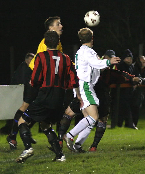 Simon Davey gathers the ball with Dan Gauntlett rushing in
