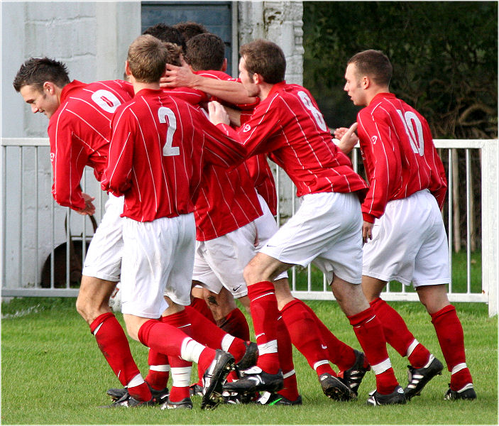 Mike Huckett puts Arundel one up on three minutes and is mobbed by team mates 
