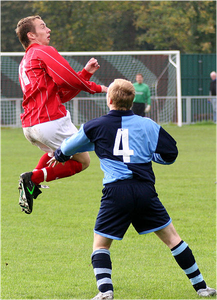 Mike Huckett wins a header with Tom Carter (4) close by
