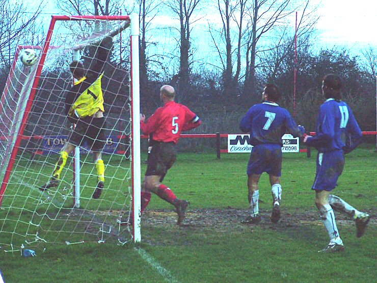 Adam Laundon, Shoreham keeper sees the ball to safety as Tony Miles charges past Ben Milford (7) and Ben Boiling (11)
