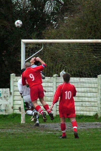 Luke Jones (9) and keeper Barry Squires go up for the ball with John Price sandwiched between them and Ian Wallace following up
