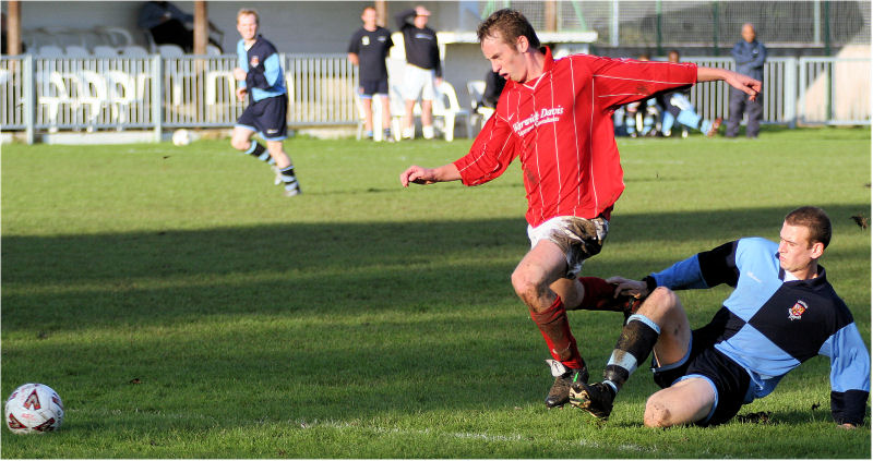 Mike Huckett is tackled on the edge of the box by Stuart Read
