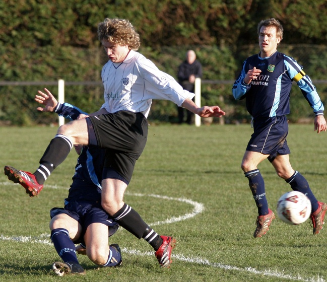 Glen Matten gets the ball away from Roy Pook
