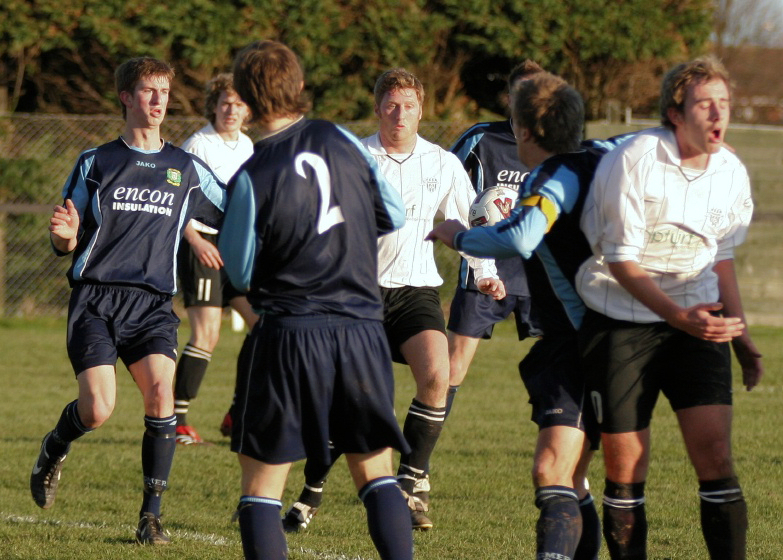 Matt Beeston chests the ball down with Jay Head looking to win it
