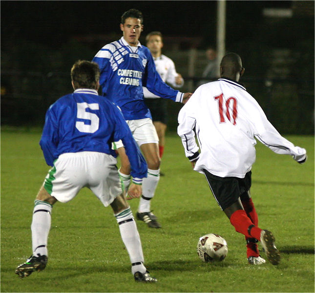 James Bamfo (10) cuts in between Paul Guarnaccio (5) and Steve Bernard
