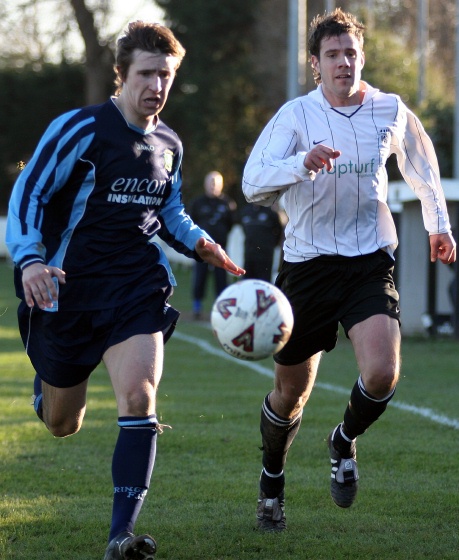 Glen Matten and Kevin Budge chase the ball
