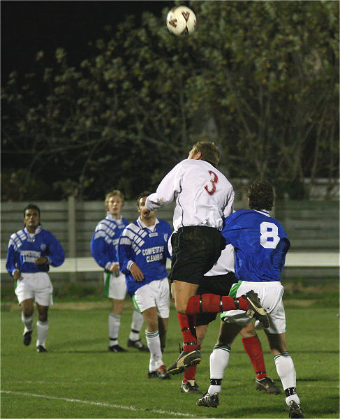 James Heller (3) gets above Neil Murfin (8) for this header
