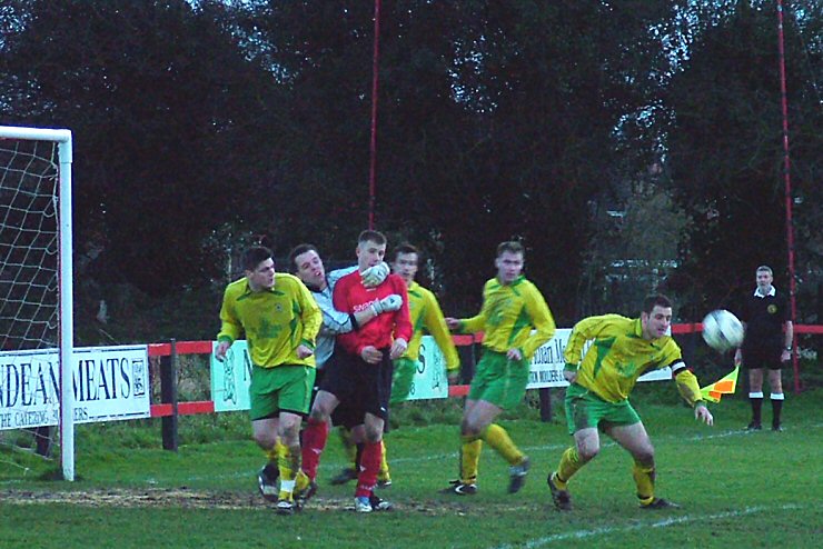 Mark Drinkwater clears for Westfield while Danny Curd is held back
