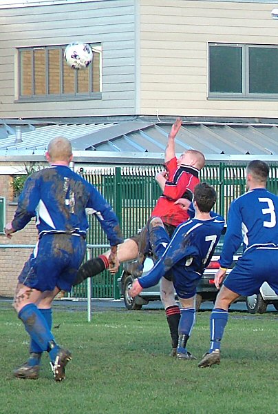 Ryan Morten (7) tangles with Rob Mills with Russ Tomlinson (4) and Kevin Clayton (3) close by
