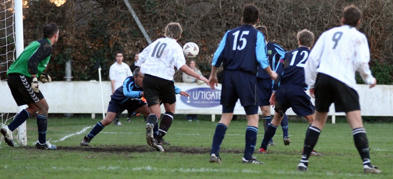 Paul Thomsett heads clear in this scramble in the Ringmer goalmouth
