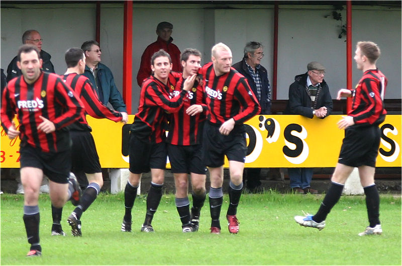 ... and he is congratulated by Marc Cooper and Kane Evans
