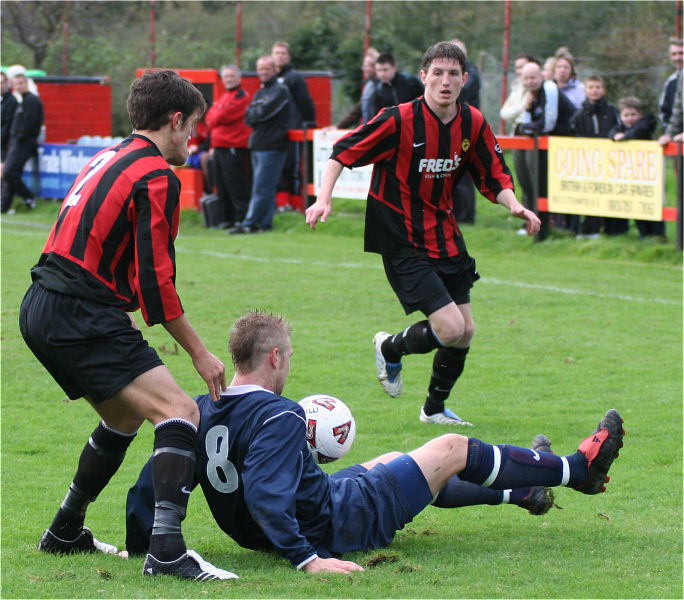 Lee Farrell goes to ground with Mark Dixon (2) and Adam Burton close by

