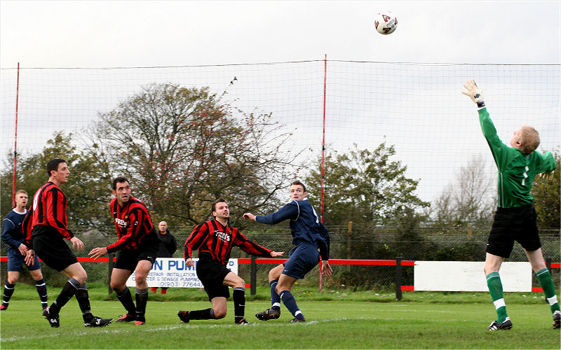Dave Walker loops the ball over Tom Rand but a goal is ruled out
