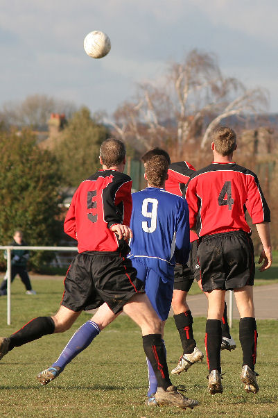 Wayne Mewett (hidden) heads away from Andy Smart (9) with Lionel  Woodroofe (5) and Justin Mewett (4) close by
