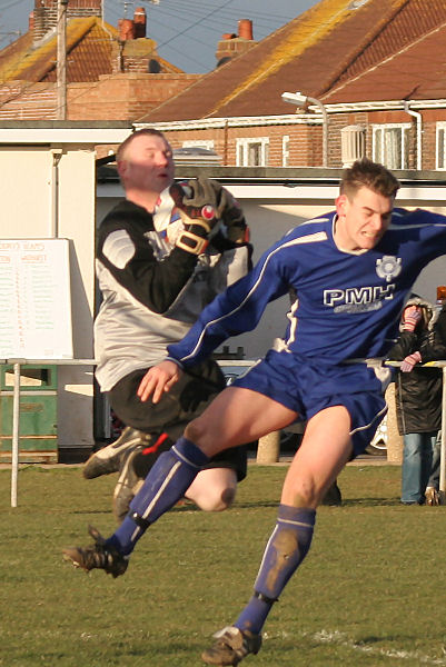 John Sutton collects under pressure from Craig Cox
