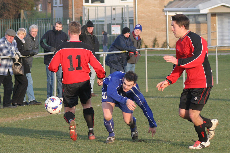 Craig Cox gets the ball past Paul Molineux (11) but Wayne Mewett puts it out for a throw
