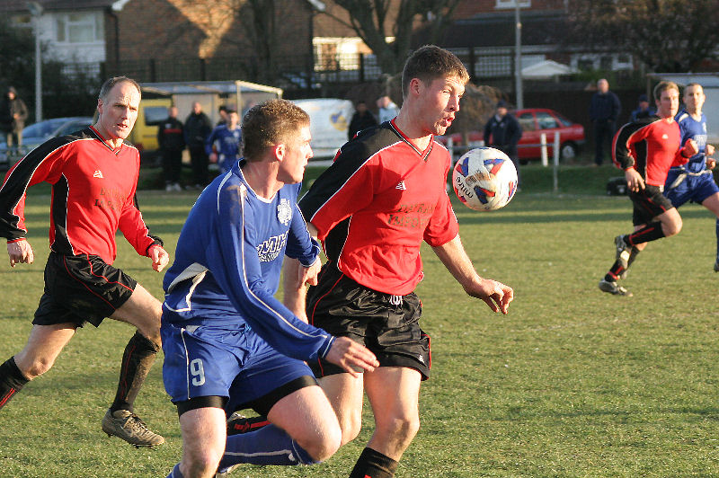 Justin Mewett gets between the ball and Andy Smart (9)
