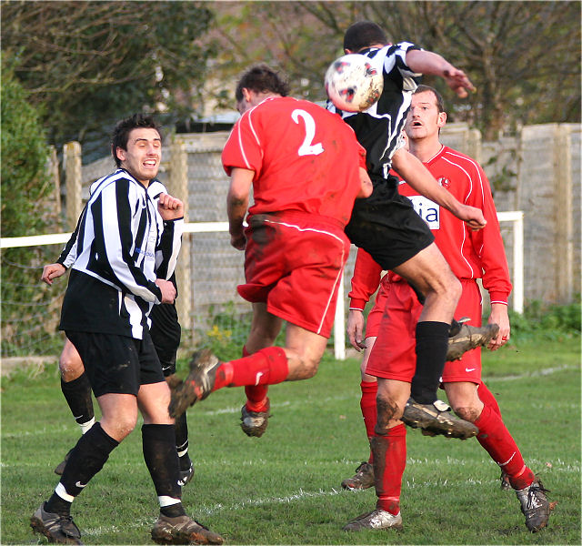 Paul Clarke and James Edmonds (2) go up for the ball
