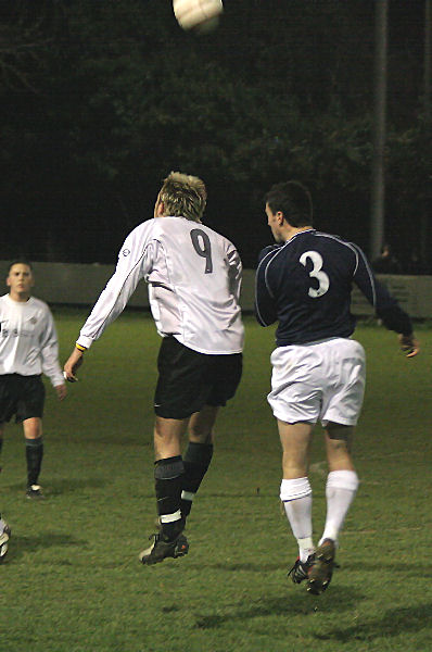 Josh Biggs wins this header from Nick Levett
