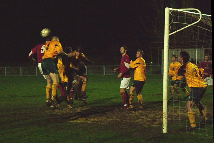 The two captains Barry Pidgeon (5) and Eddie French (4) jump for this header
