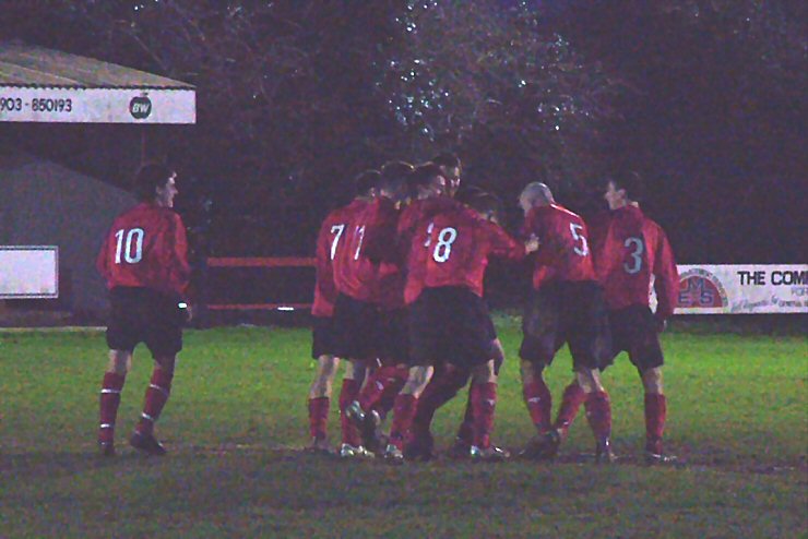 Pete Christodoulou is mobbed by team mates after his 30 yard blast settles the result at 3-1 to Wick
