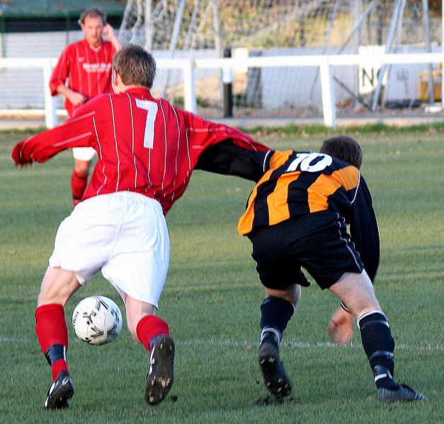 Lee Barnard (7) goes past Nick Flint (10)
