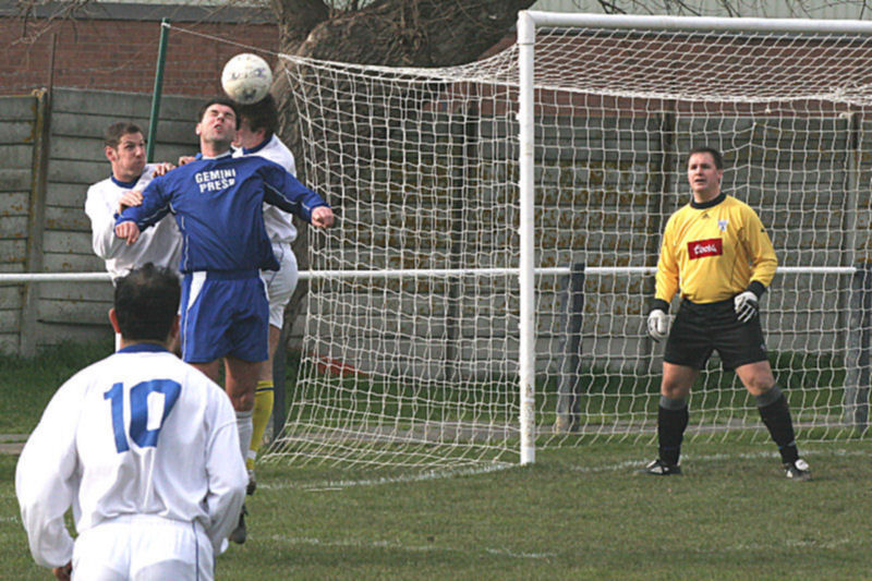 Richard Carter climbs for this header under pressure from Jamie Fiveash
