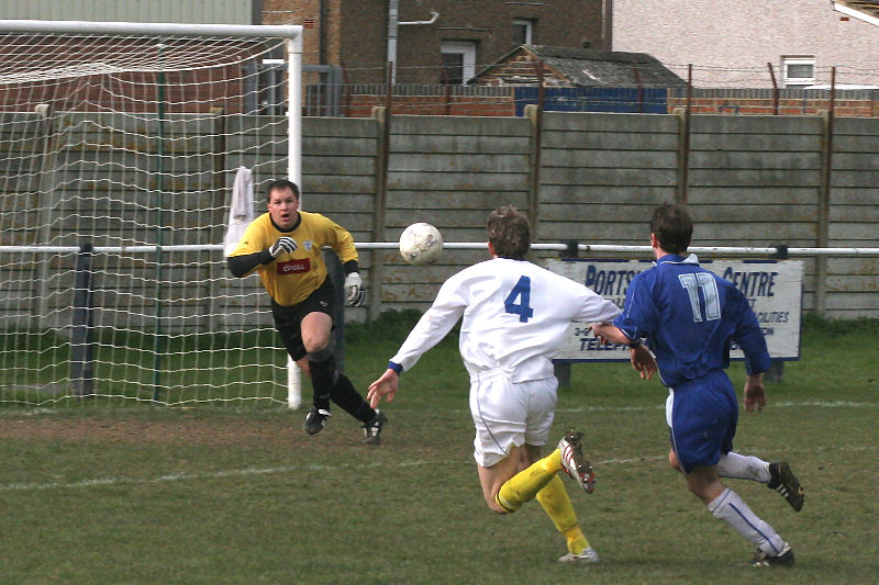 Keeper Darren Lambert is ready as Christian Troak (11) and Phil Williamson (4) try to win the ball
